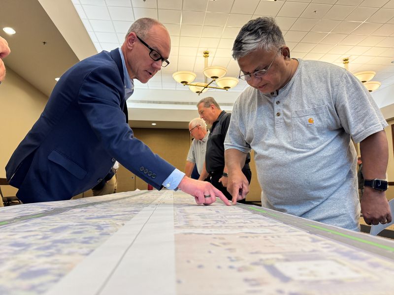 Canton resident Iranna Kona, right, talks with Matt Stacey of Wade Trim, who also lives near Ford Road in Canton, about details of the upcoming reconstruction of Ford Road.