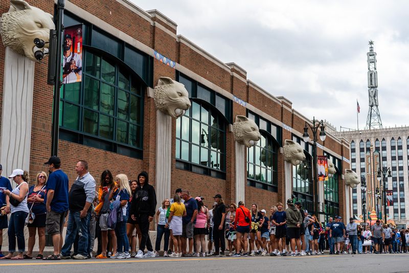 Detroit Tigers fans line up to enter before a game against the Kansas City Royals at Comerica Park in Detroit on Saturday, Aug. 23, 2025.