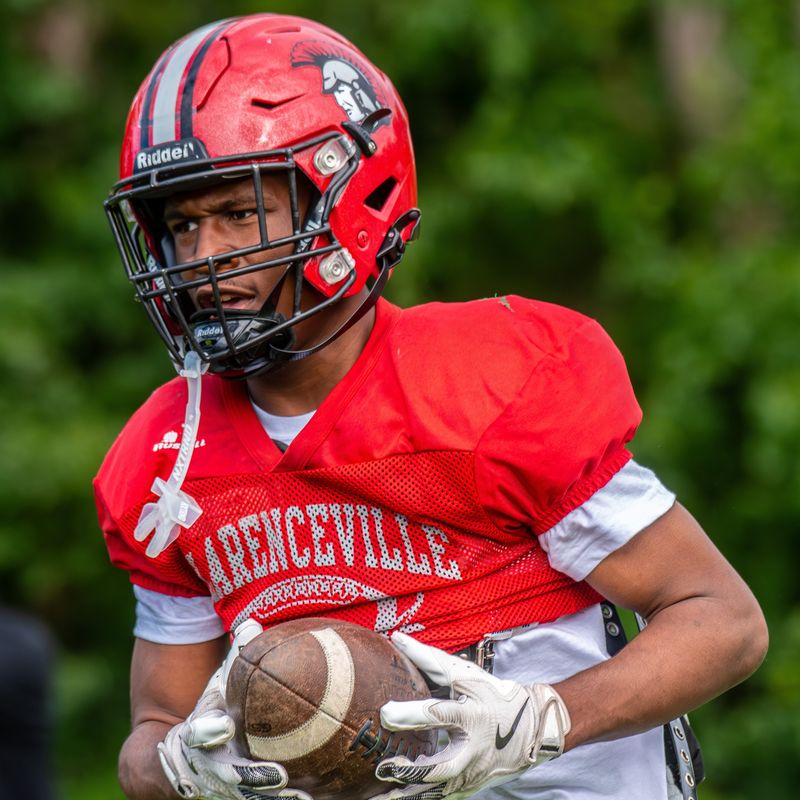 Livonia Clarenceville's Joshua Rogers snags an interception during a football practice on Monday, Aug. 25, at Shaw Stadium.