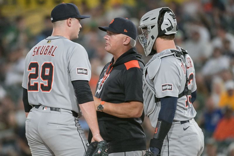 Aug 25, 2025; West Sacramento, California, USA; Detroit Tigers manager A.J. Hinch (14) and catcher Dillon Dingler (13) visit the mound to speak with pitcher Tarik Skubal (29) during the fourth inning of the game against the Athletics at Sutter Health Park. Mandatory Credit: Ed Szczepanski-Imagn Images