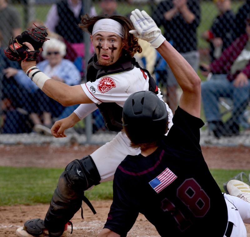 2022: Catcher Noah Miller of Monroe sets to place the tag onto Garrett Sharp of Dexter who beat the tag and called safe which tied the score in the sixth inning 4-4 Friday, May 27, 2022. Monroe gave up four runs in the seventh for the lost 8-4.