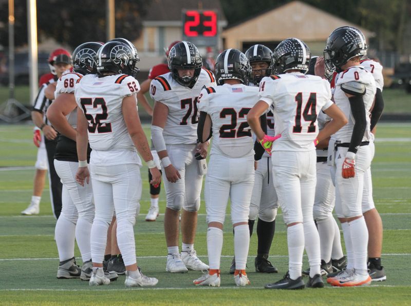 The Trojans huddle up before a play call on Thursday against Coldwater.