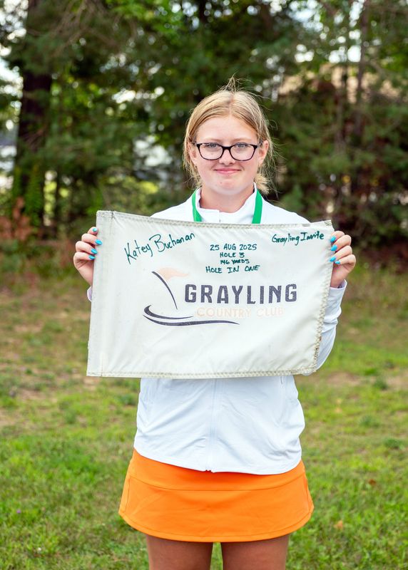 Harbor Springs' Katey Buchanan shows off her hole-in-one flag from the Grayling Country Club's No. 3 hole, which Buchanan aced with a six-hybrid iron. It came as her first career hole-in-one and has fueled a strong start.