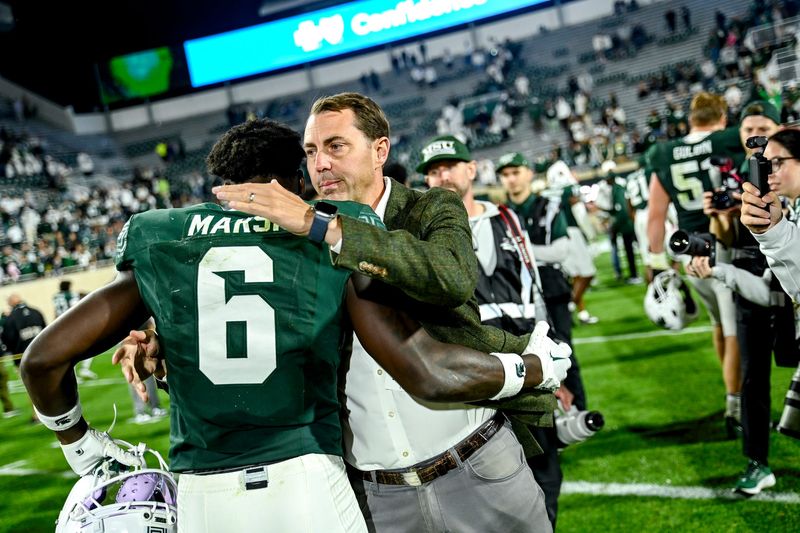 Michigan State's Athletic Director J Batt, right, hugs Nick Marsh after the Spartans win over Western Michigan on Friday, Aug. 29, 2025, in East Lansing.