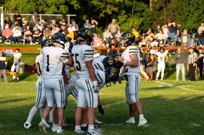 Hillsdale quarterback Evan Towne gets the play call to the huddle.