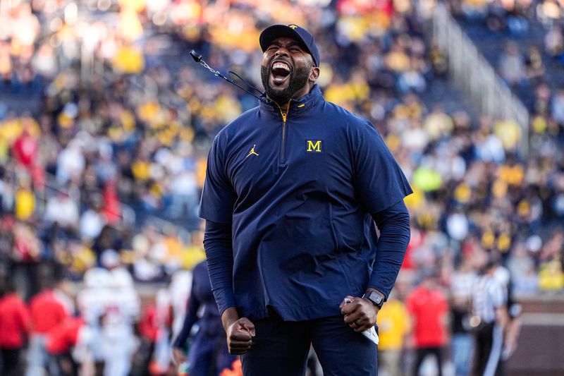 Michigan head coach Sherrone Moore fires up the student section during warm up ahead of the New Mexico game at Michigan Stadium in Ann Arbor on Saturday, August 30, 2025.