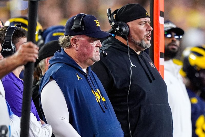 Michigan defensive coordinator Wink Martindale, left, and defensive line coach Lou Esposito watch a play against New Mexico during the first half at Michigan Stadium in Ann Arbor on Saturday, August 30, 2025.