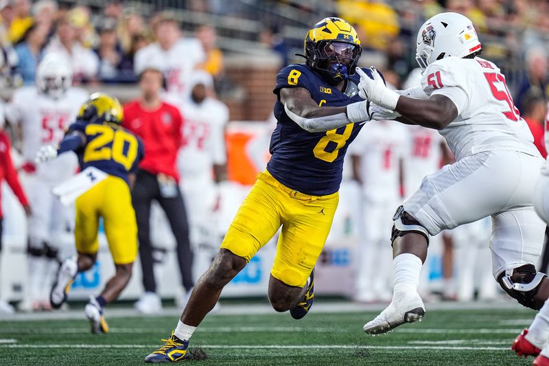 Michigan edge Derrick Moore (8) goes against New Mexico offensive lineman Malik Aliane (51) during the first half at Michigan Stadium in Ann Arbor on Saturday, August 30, 2025.