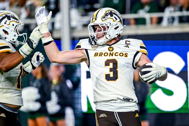 Western Michigan's Tate Hallock celebrates his interception for a touchdown against Michigan State during the fourth quarter on Friday, Aug. 29, 2025, in East Lansing.