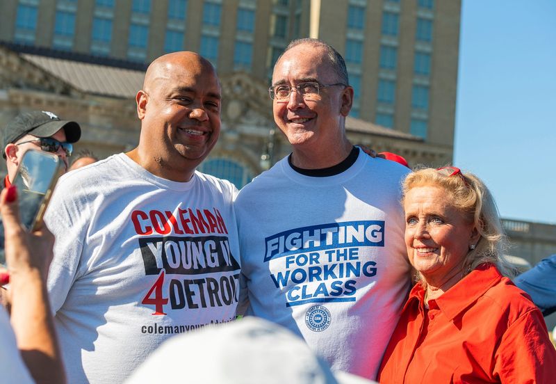 UAW President Shawn Fain (center) takes a photo with Coleman Young II (left) and Rep. Debbie Dingell prior to speaking during Labor Day activities at Michigan Central in Detroit on Monday, Sept. 1, 2025.