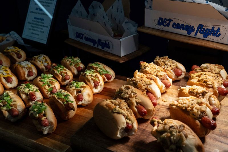 A Coney Flight with four mini coney dogs, classic, pickled onion and spicy honey mustard, crispy shallot with brown mustard, and spicy mustard with green onion and Dijon, is offered during the Detroit Lions 2025 Food & Beverage Media Preview at Ford Field on Wednesday, Sept. 3, 2025.