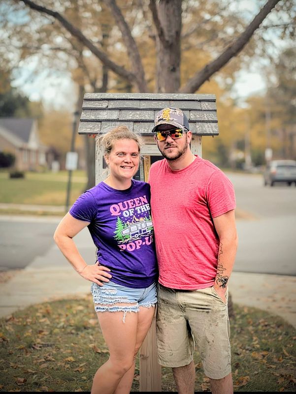 Andy and Katie Curtiss stand in front of an area Little Free Library. The Monroe Township couple is collecting children's books and distributing them to Little Free Libraries and through the local Sleep in Heavenly Peace bed ministry.