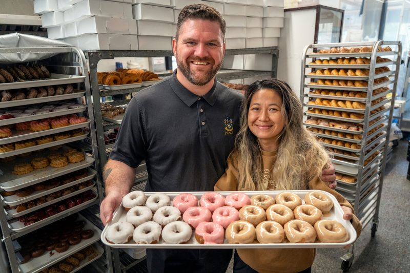 Dutch Girl Donuts owners Paddy Lynch, left, and Nhu Truong pose for a portrait, Tuesday, Aug. 5, 2025, in Detroit.