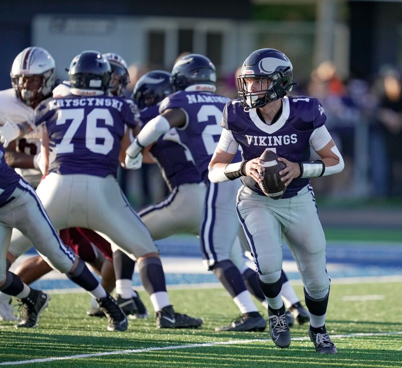 Marysville quarterback Brady Wright rolls left during a game against Hazel Park at Walt Braun Viking Stadium in Marysville on Friday, Sept. 5, 2025.