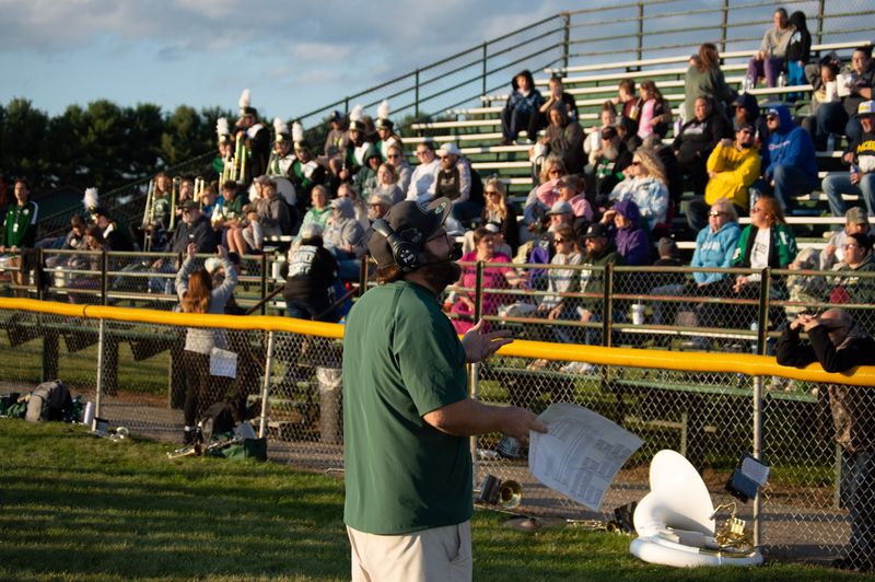 Coach Kody Hodshire looks up to the press box to relay information from the field.