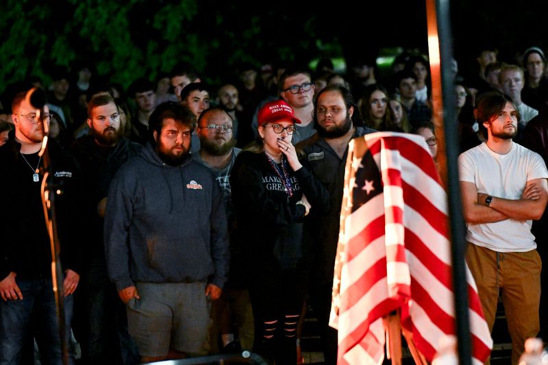 People gather for a vigil for conservative activist Charlie Kirk on Thursday, Sept. 11, 2025, outside Wells Hall on the Michigan State University campus in East Lansing. Kirk was shot and killed Sept. 10 while speaking on a Utah college campus. The gathering was organized by MSU's Turning Point chapter and the Michigan State University College Republicans organization.