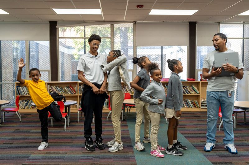 Students line up for shoe measurements during the Detroit Free Press Kids Marathon Presented by Priority Health, shoe measurement day at Bates Academy in Detroit on Friday, Sept. 12, 2025.