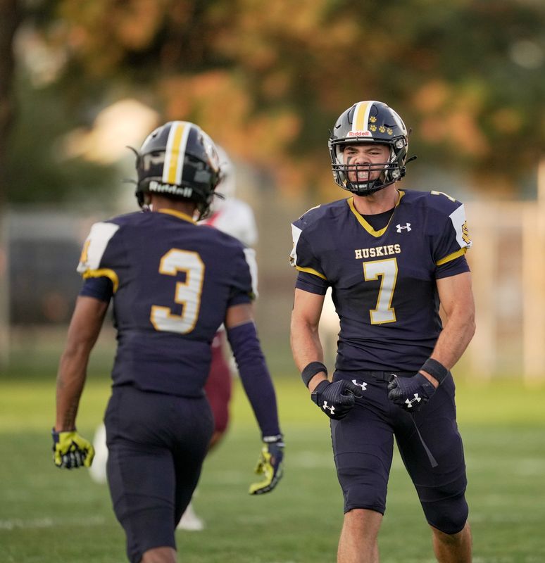 Port Huron Northern's Lincoln Watkins (7) and Joe Lincoln (3) celebrate after a play during a game against Utica Ford at Memorial Stadium in Port Huron on Friday, Sept. 12, 2025.