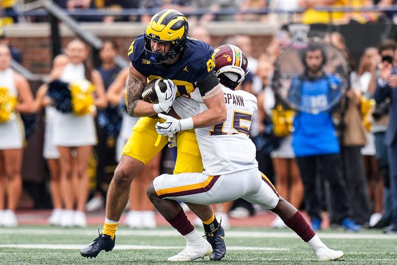 Michigan tight end Hogan Hansen (80) makes a catch against Central Michigan defensive back Caleb Spann (15) during the first half at Michigan Stadium in Ann Arbor on Saturday, Sept. 13, 2025.