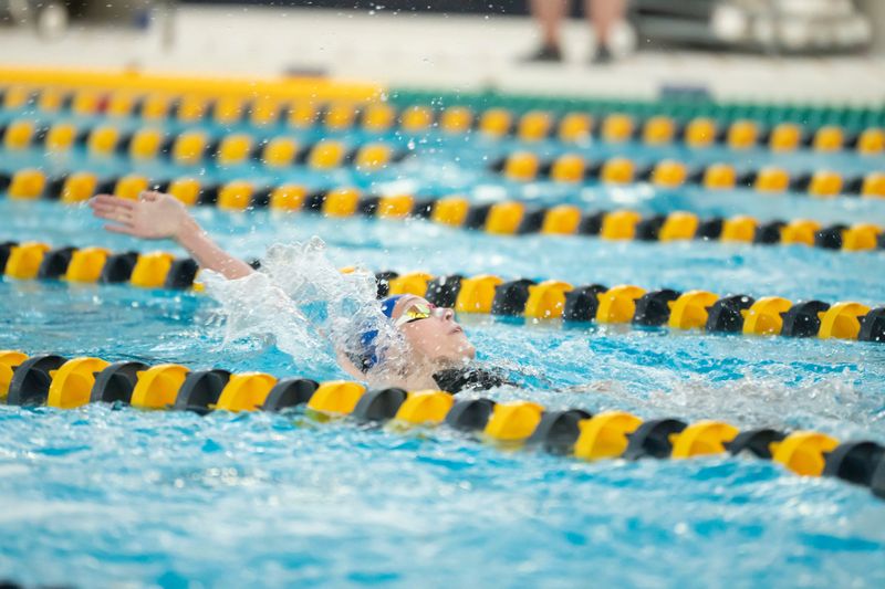 Harper Creek's Ella Laupp swims backstroke in the 200 yard individual medley race during the All-City swim meet at Battle Creek Central on Saturday, Sept. 13, 2025.