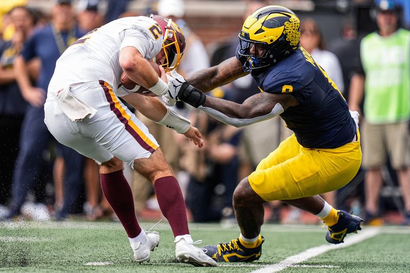 Michigan edge Derrick Moore (8) tackles Central Michigan quarterback Joe Labas (2) during the second half at Michigan Stadium in Ann Arbor on Saturday, Sept. 13, 2025.