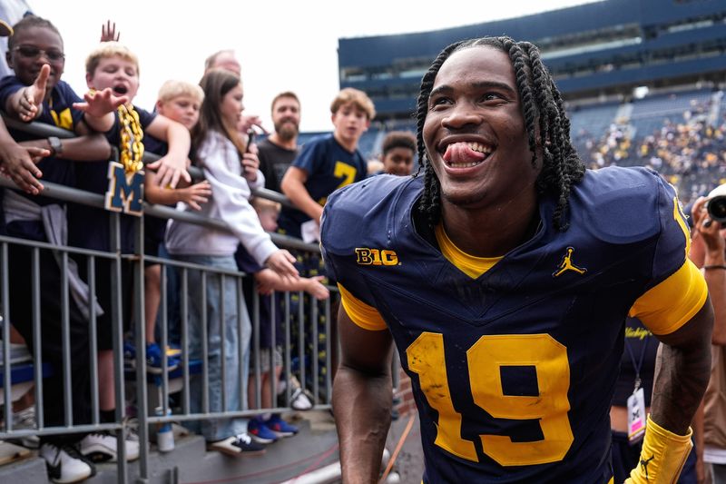Michigan quarterback Bryce Underwood (19) smiles at fans as he walks up the tunnel after 63-3 win over Central Michigan at Michigan Stadium in Ann Arbor on Saturday, Sept. 13, 2025.