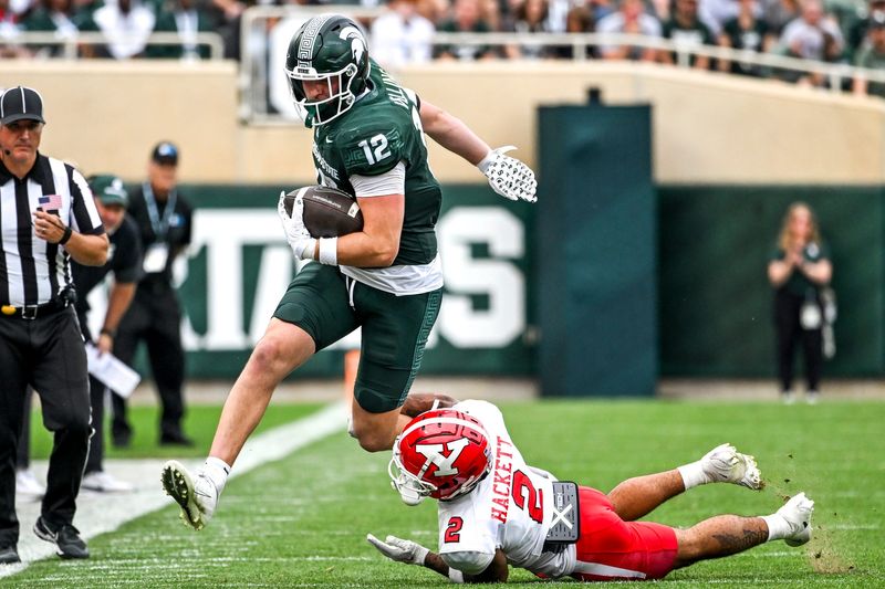 Michigan State's Jack Velling, left, catches a pass as Youngstown State's Isaiah Hackett defends during the third quarter on Saturday, Sept. 13, 2025, at Spartan Stadium in East Lansing.