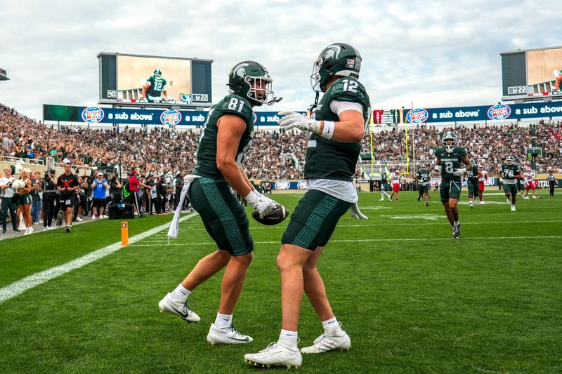 Michigan State's Michael Masunas, left, celebrates his touchdown catch with Jack Velling against Youngstown State during the third quarter on Saturday, Sept. 13, 2025, at Spartan Stadium in East Lansing.