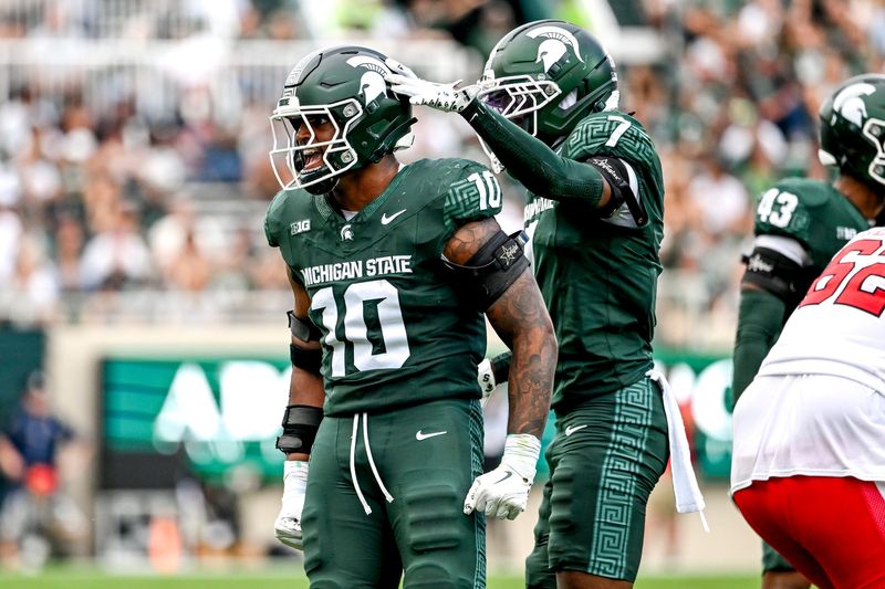 Michigan State's Wayne Matthews III, left, celebrates with Nikai Martinez after a tackle against Youngstown State during the third quarter on Saturday, Sept. 13, 2025, at Spartan Stadium in East Lansing.
