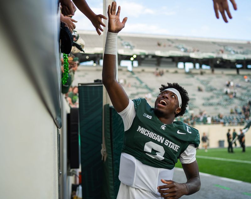 Michigan State quarterback Aidan Chiles (2) high fives fans after defeating Youngstown State at Spartan Stadium in East Lansing on Saturday, September 13, 2025.