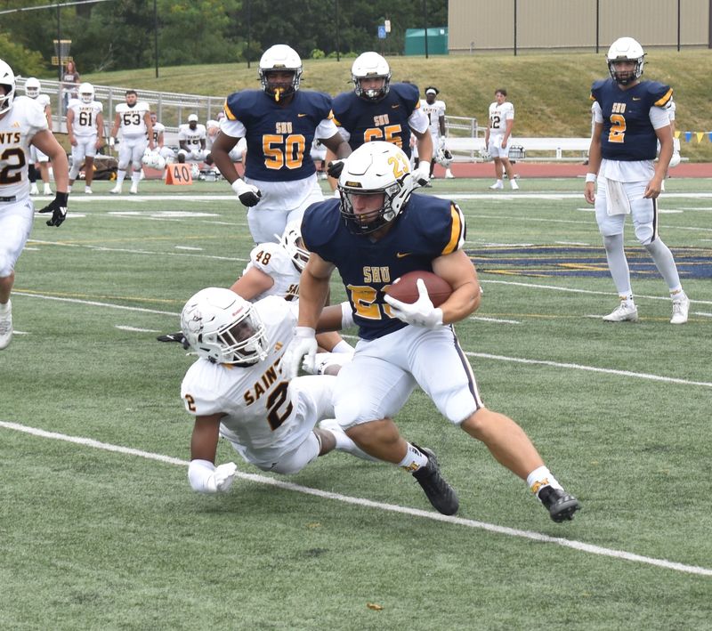 Siena Heights running back Brendan Haisenleder (23) makes a defender miss Saturday versus Saint Francis