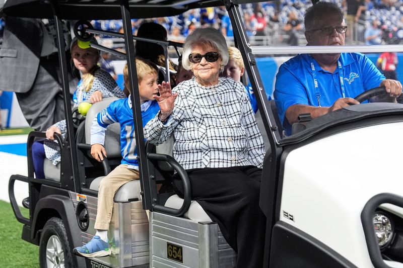 Martha Ford waves at fans as she arrives to watch warm up ahead of the game between Detroit Lions and Chicago Bears at Ford Field in Detroit on Sunday, Sept. 14, 2025.