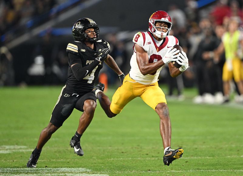 Sep 13, 2025; West Lafayette, Indiana, USA; USC Trojans wide receiver Ja'Kobi Lane (8) catches a pass in front of Purdue Boilermakers defensive back Hudauri Hines (4) during the second half at Ross-Ade Stadium. Mandatory Credit: Marc Lebryk-Imagn Images