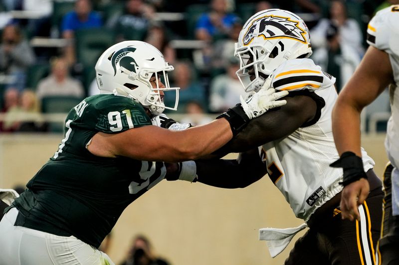Aug 29, 2025; East Lansing, Michigan, USA; Michigan State Spartans defensive lineman Alex VanSumeren (91) engages with Western Michigan Broncos offensive lineman Raheem Anderson II (62) during the 2nd quarter at Spartan Stadium. Mandatory Credit: Brendan Mullin-Imagn Images