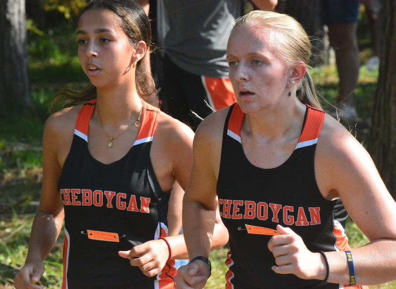 Cheboygan's Ella LaRocque (left) and Addison Ptasnik run during the Cheboygan Invitational cross country event at the Cheboygan Golf & Country Club on Wednesday, Sept. 17.