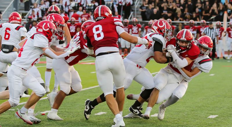 The Bedford defense drags down a ballcarrier during a 24-7 victory over Monroe on Friday, Sept. 19, 2025.
