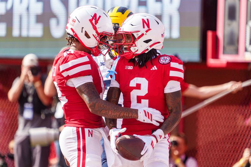 Nebraska Cornhuskers wide receivers Jacory Barney Jr. (2) and Nyziah Hunter (13) celebrate after a touchdown against the Michigan Wolverines during the second quarter at Memorial Stadium, Saturday, Sept. 20, 2025 in Lincoln, Nebraska.