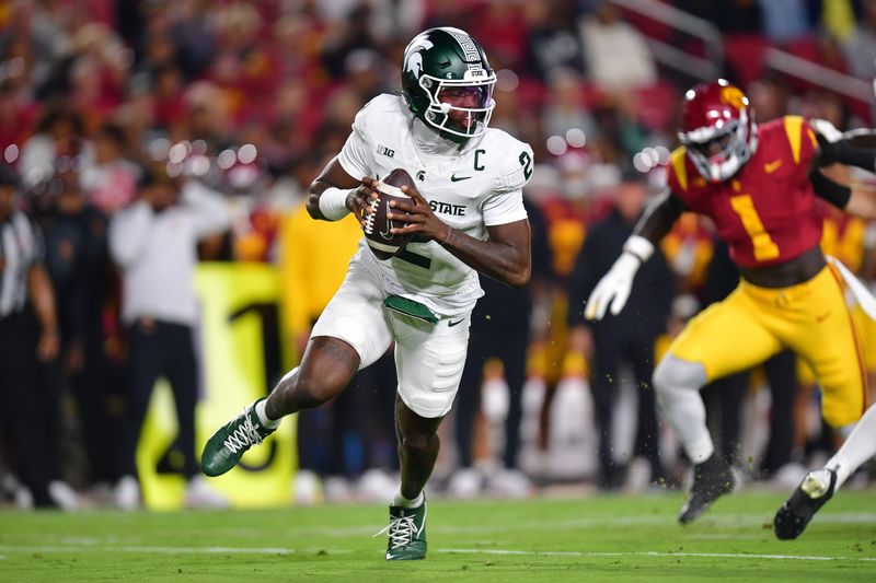 Sep 20, 2025; Los Angeles, California, USA; Michigan State Spartans quarterback Aidan Chiles (2) moves out to pass against the Southern California Trojans during the first half at the Los Angeles Memorial Coliseum. Mandatory Credit: Gary A. Vasquez-Imagn Images