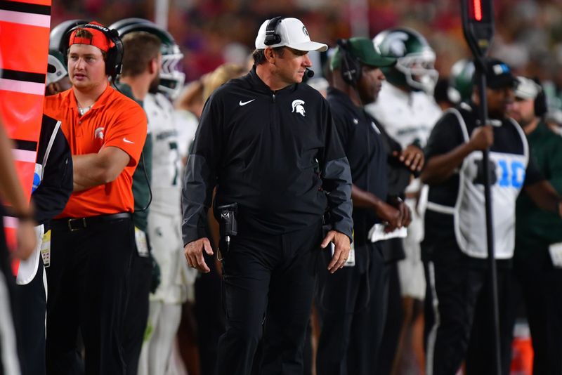 Sep 20, 2025; Los Angeles, California, USA; Michigan State Spartans head coach Jonathan Smith watches game action against the Southern California Trojans during the second half at the Los Angeles Memorial Coliseum. Mandatory Credit: Gary A. Vasquez-Imagn Images