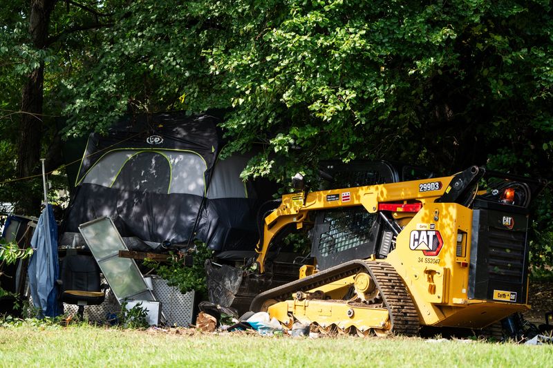 Washington, DC, crews clear a homeless encampment near the Kennedy Center on Aug. 14, 2025.