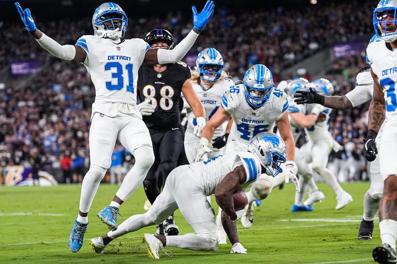 Detroit Lions cornerback DJ. Reed (4), center, recovers a Baltimore Ravens fumble as safety Kerby Joseph (31), left, celebrates during the second half at M&T Bank Stadium in Baltimore, Md. on Monday, Sept. 22, 2025.