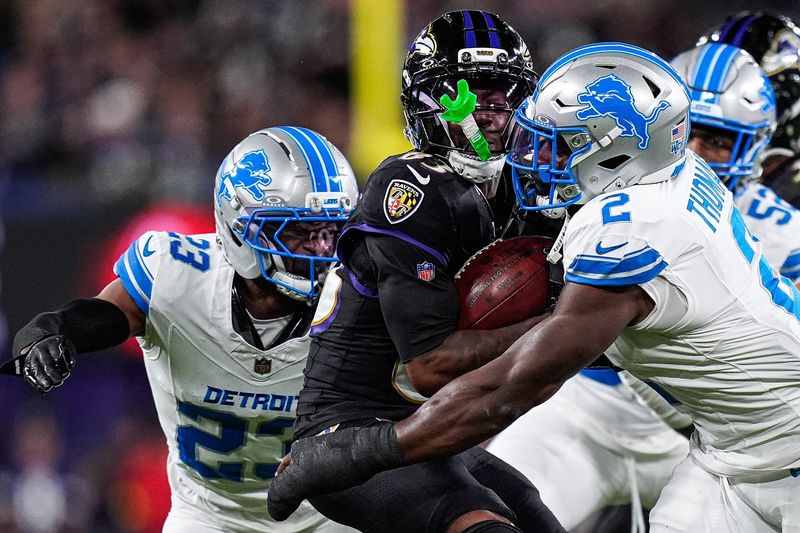 Detroit Lions safety Daniel Thomas (2), right, and cornerback Rock Ya-Sin (23), left, tackle Baltimore Ravens kick returner LaJohntay Wester (83) during the second half at M&T Bank Stadium in Baltimore, Md. on Monday, Sept. 22, 2025.