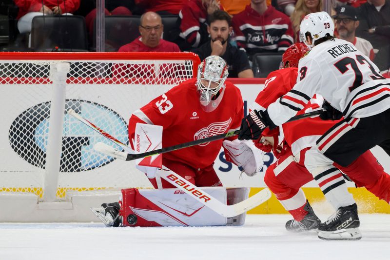 Detroit goaltender Sebastian Cossa stops a shot during the first period.