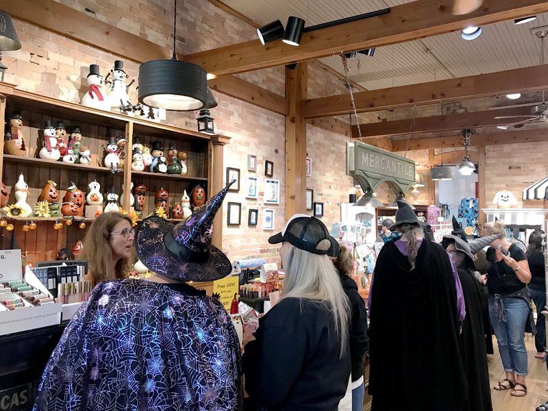 People shop at downtown Petoskey stores in costume during the 2024 Witches Night Out event.