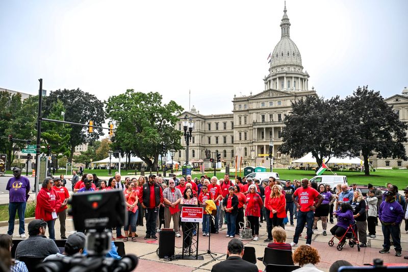Members of the Michigan Education Association protest the state budget fight and potential state government shutdown on Wednesday, Sept. 24, 2025, outside city hall in Lansing.