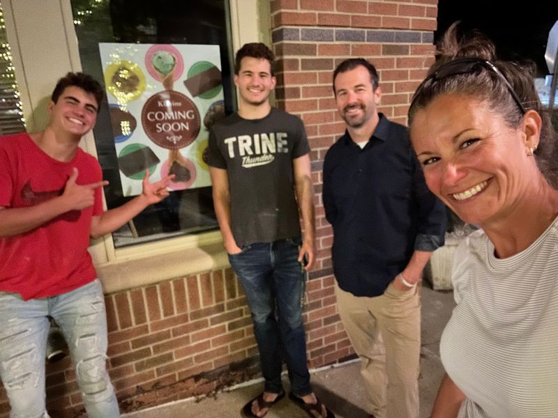 From left, Joshua Styles and Rory Styles, along with parents Bryan and Keleigh Styles, pose for a photo outside the new Kilwins location in downtown Northville.