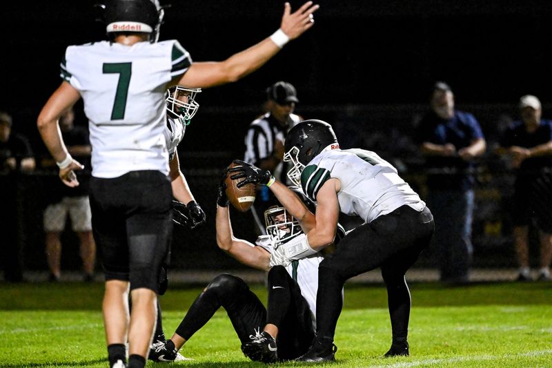 Williamston's Thomas Pratt, center, celebrates an interception with Parker Friess, right, and Thomas Pratt during the second quarter in the game against St. Johns on Friday, Sept. 26, 2025, at St. Johns High School.