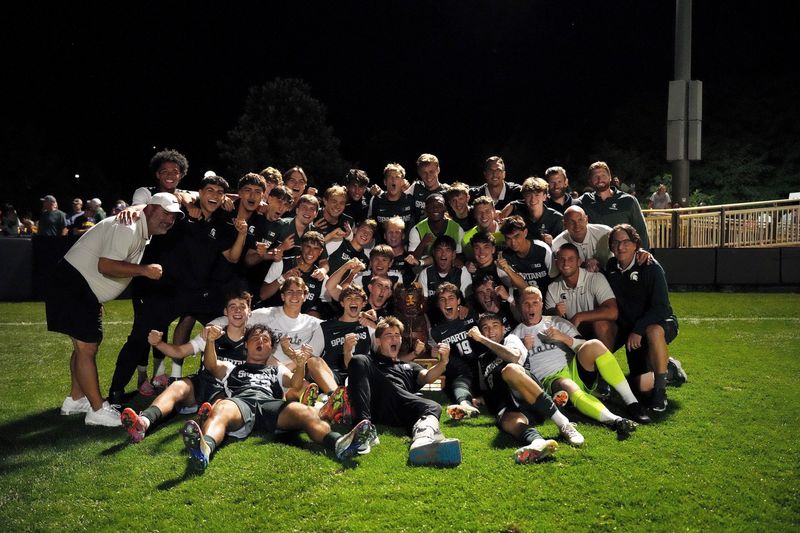 Michigan State's men's soccer team celebrates its 2-1 win at Michigan on Friday night.