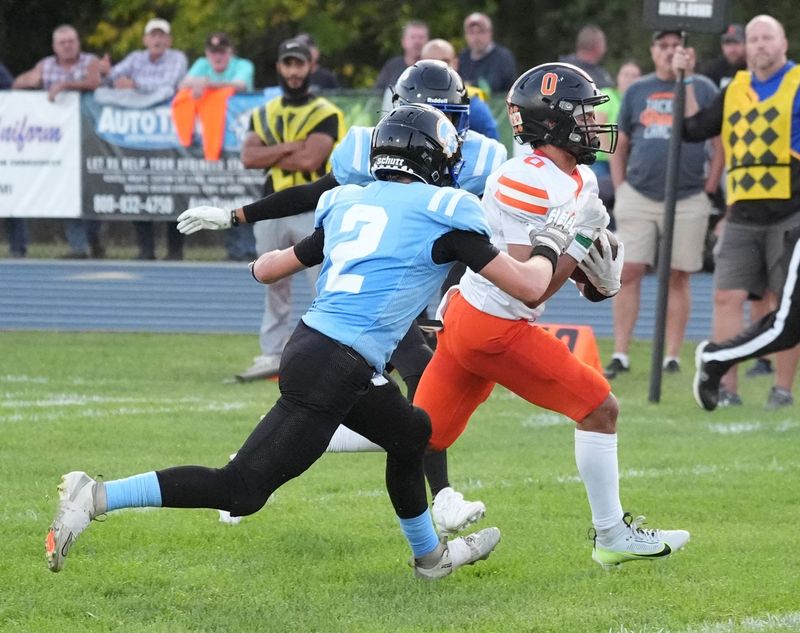 Hudson's Beckett Campbell (0) breaks off a big run while Adrian Madison's Cam Barber (2) chases the play