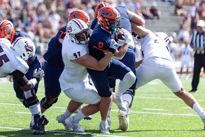 Hope's AJ Martel, right, is tackled by Alma's Jack Anderson on Saturday, Sept. 27, 2025, at Hope College's Ray & Sue Smith Stadium.